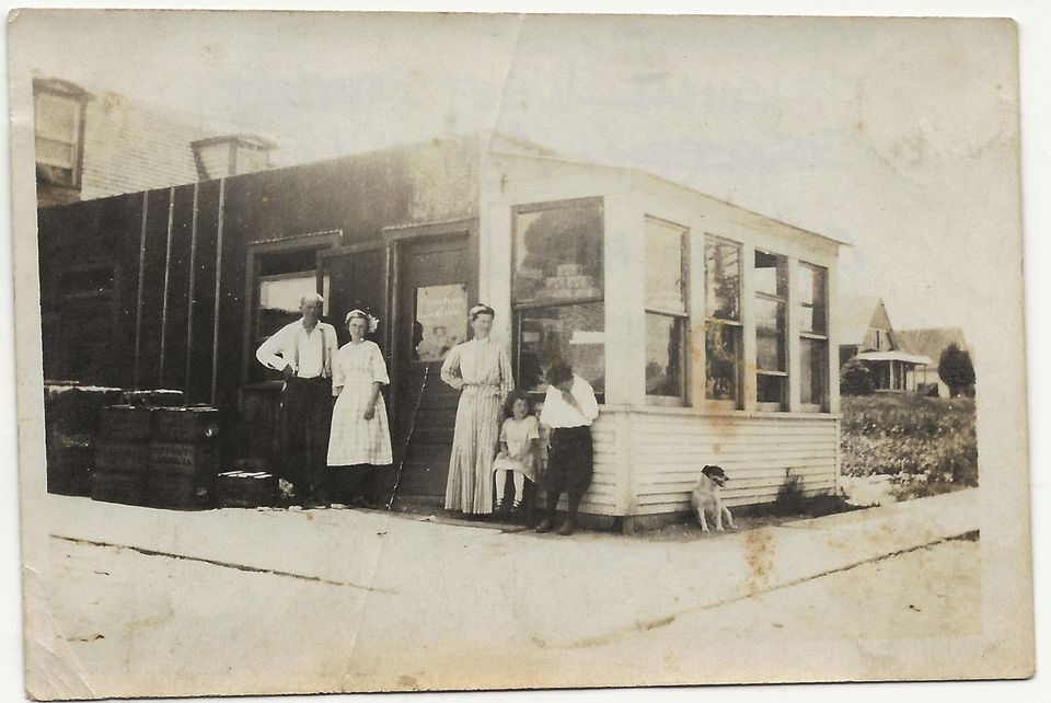1915c_frank_dixon_josie_minnie_charles_elliot_julia_pearle_front_franks_place_grocery_store_west_st_and_campus_ave..jpg